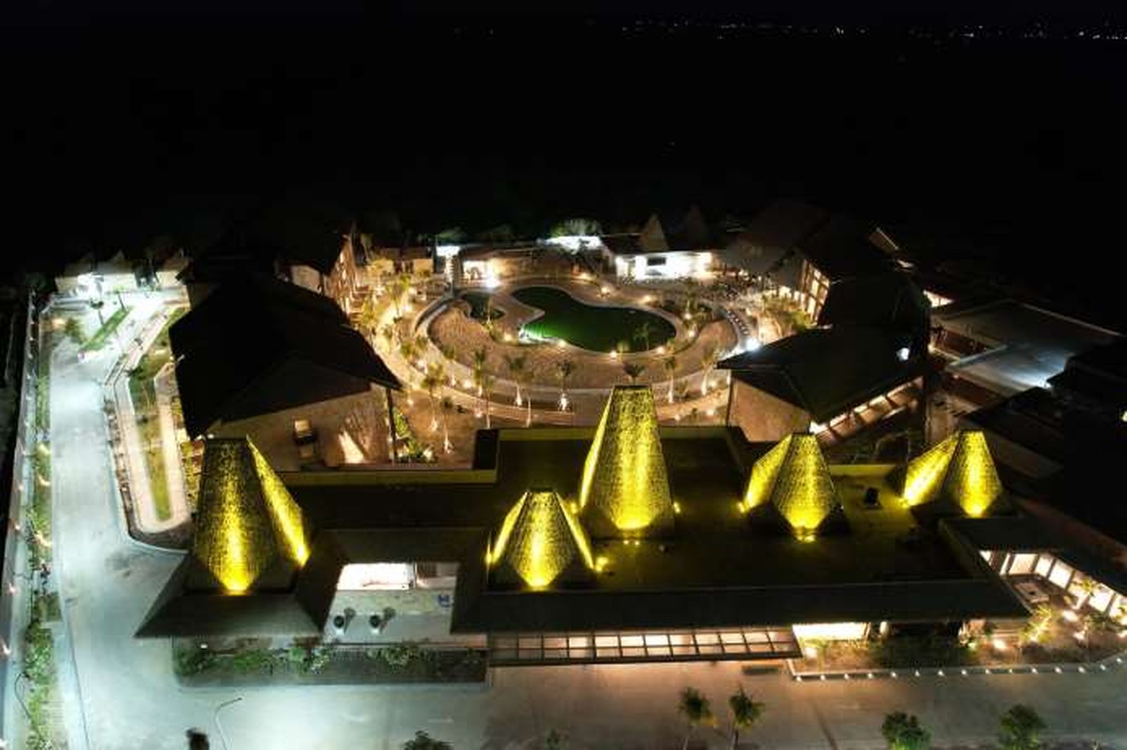 Aerial night view of a resort property with integrated lighting and network infrastructure deployed by PT Microcel Pole Indonesia