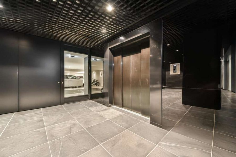 Modern elevator lobby with stainless steel lift doors