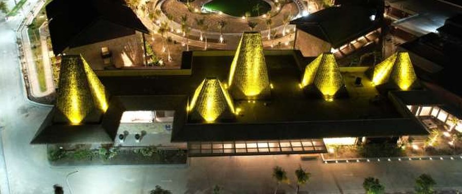 Resort exterior at night with illuminated facade, landscape and feature lighting